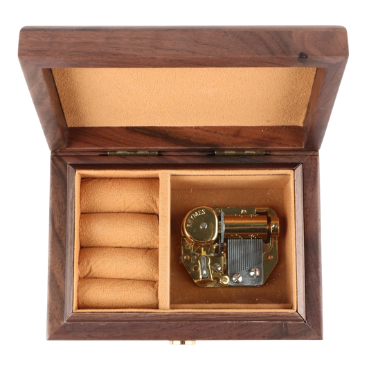 Enchanted Music Boxes walnut wood music box with gold 18-note mechanism and tan velvet ring holder interior.