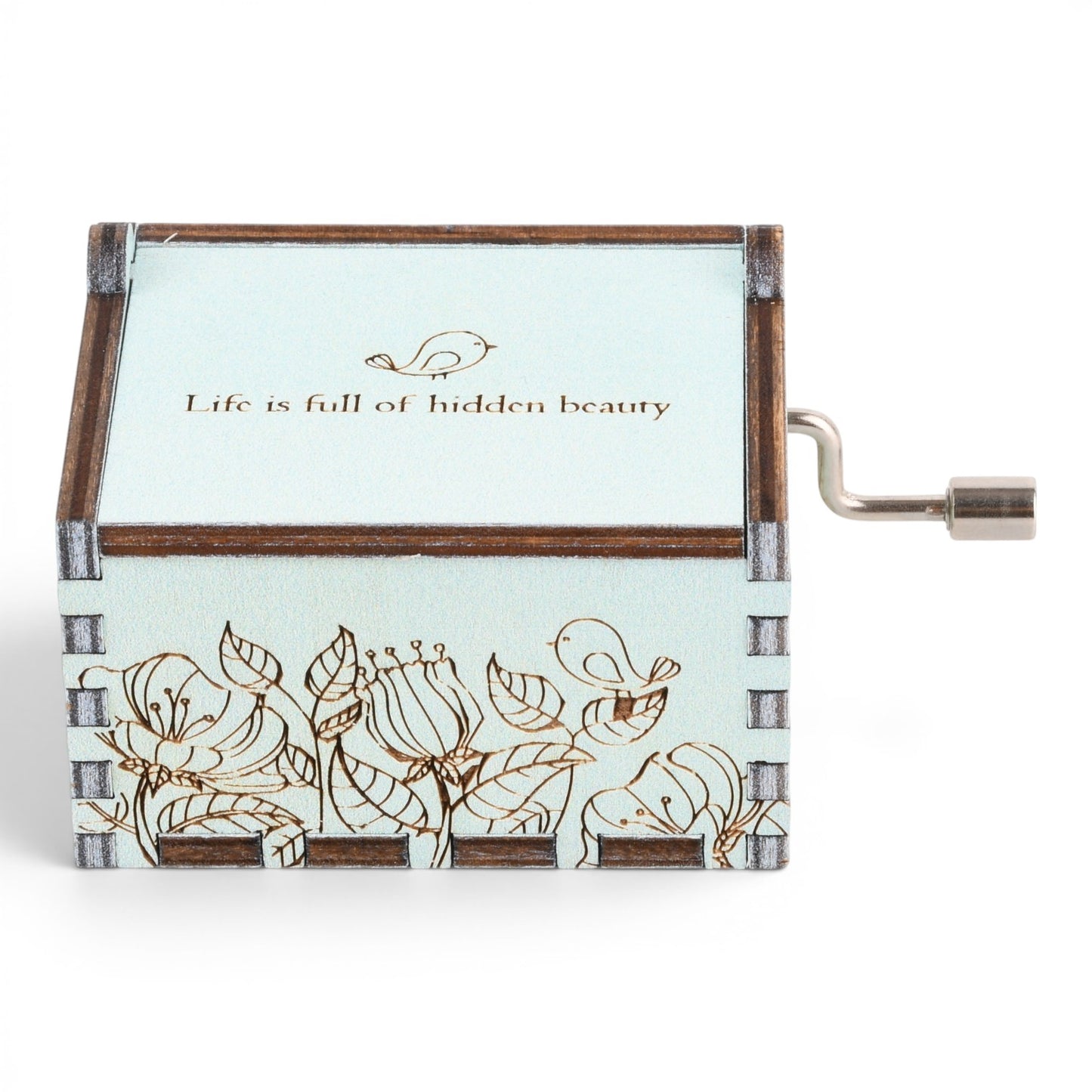 Enchanted Music Boxes singing bird hand-crank music box in light blue plywood with floral engraving and metal handle.