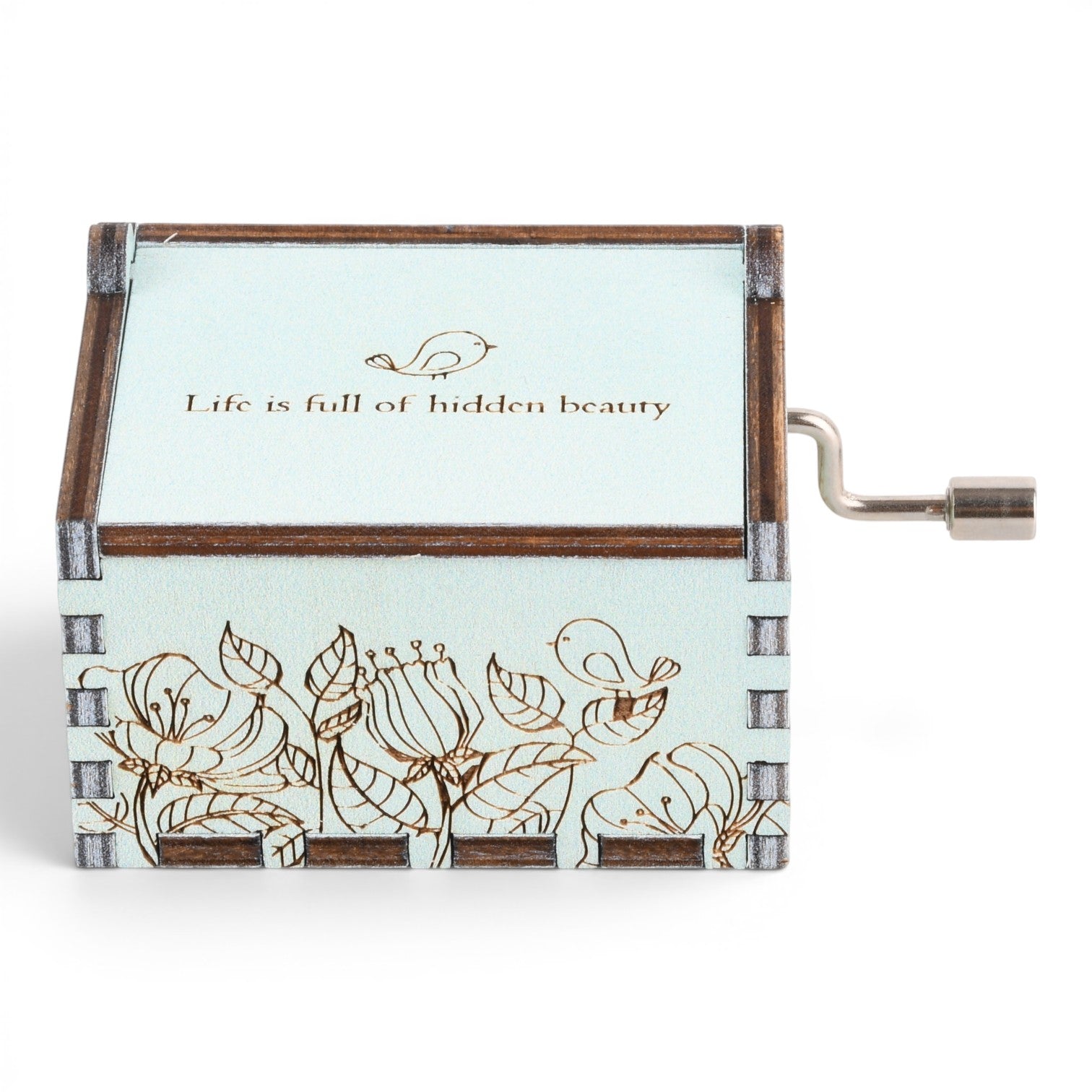 Enchanted Music Boxes singing bird hand-crank music box in light blue plywood with floral engraving and metal handle.
