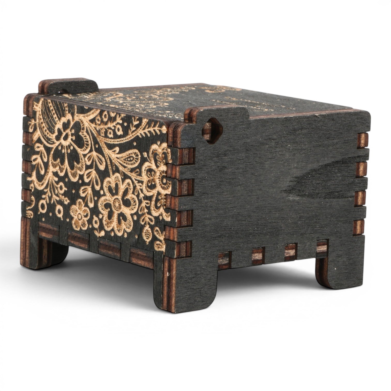 Enchanted Music Boxes wind-up music box in black plywood with intricate laser-engraved floral folk art patterns.