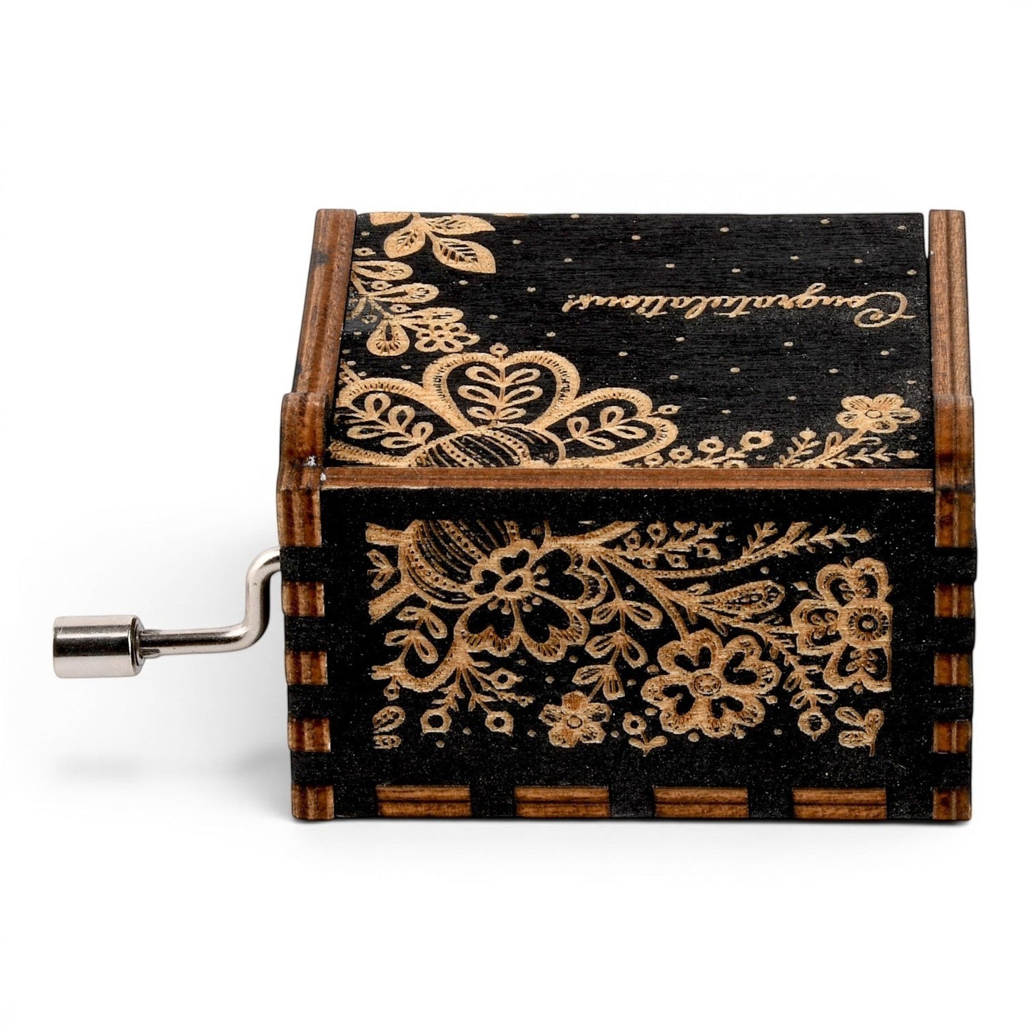 Enchanted Music Boxes hand-crank music box in black plywood with intricate laser-engraved folk art floral patterns.