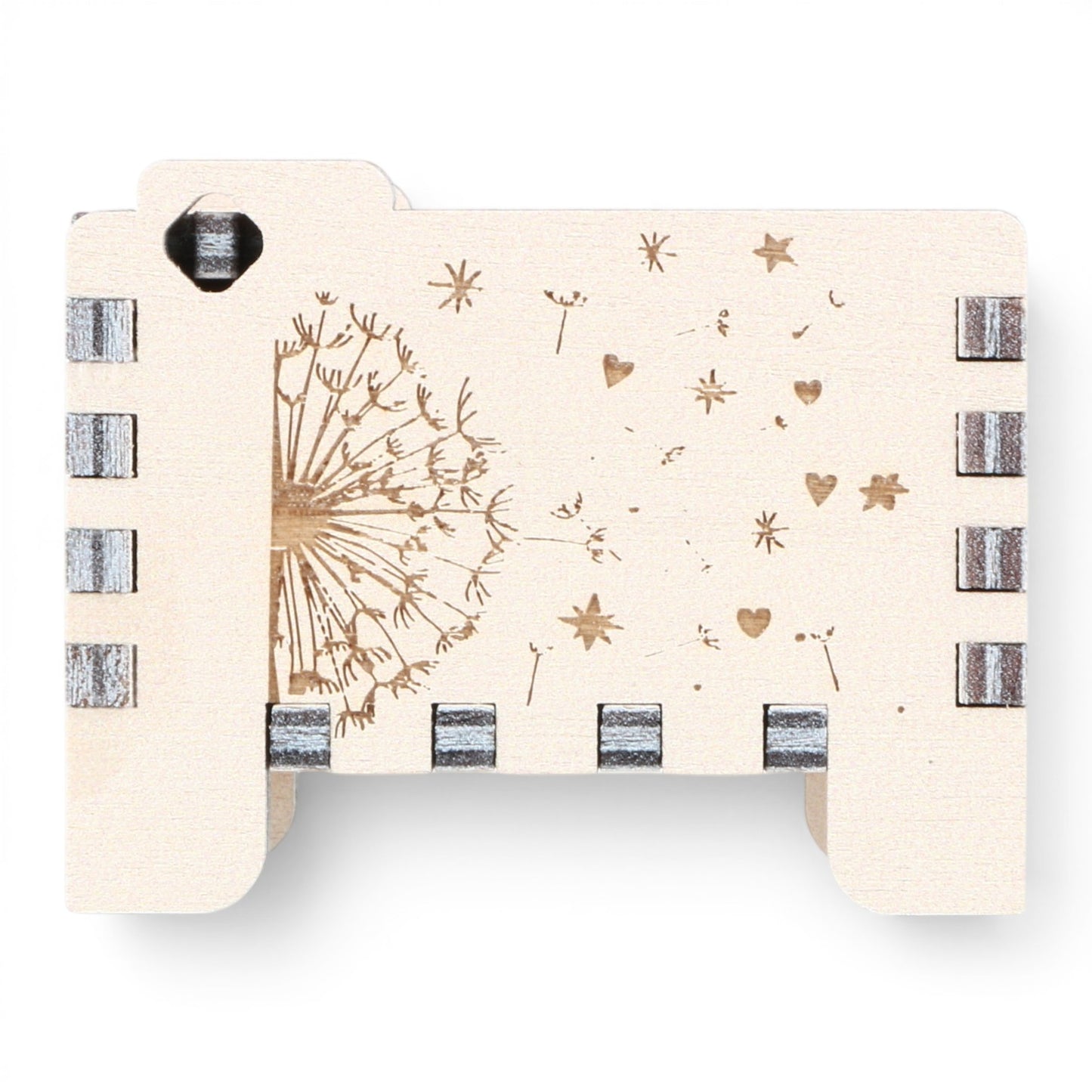 Side view of Enchanted Music Boxes plywood wind-up music box featuring laser-engraved dandelion seeds, hearts, and stars.
