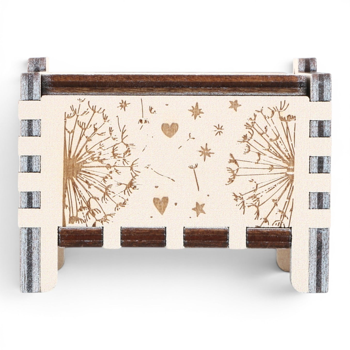 Front view of Enchanted Music Boxes plywood wind-up music box featuring laser-engraved dandelion seeds, hearts, and stars.