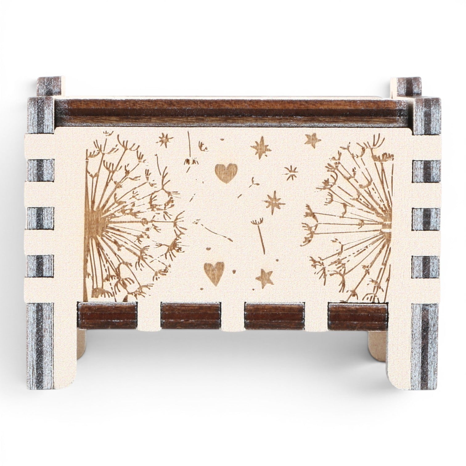 Front view of Enchanted Music Boxes plywood wind-up music box featuring laser-engraved dandelion seeds, hearts, and stars.