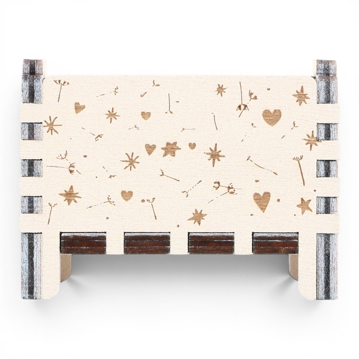 Back view of Enchanted Music Boxes plywood wind-up music box featuring laser-engraved dandelion seeds, hearts, and stars.