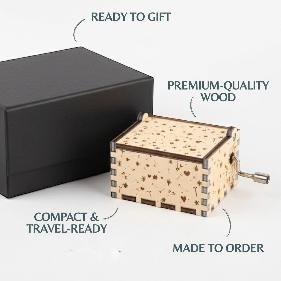 Enchanted Music Boxes Dandelions hand-crank music box in plywood with engraved dandelion, heart, and star patterns.
