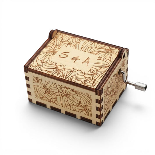Enchanted Music Boxes laser-engraved plywood music box with floral patterns and custom initials on the lid.