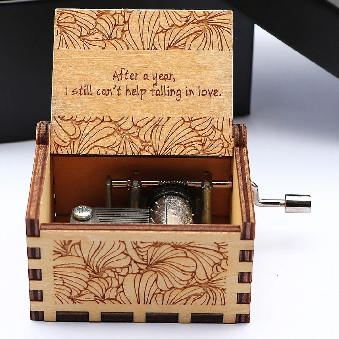 Enchanted Music Boxes hand-crank plywood music box with laser-engraved floral patterns and custom lid inscription.