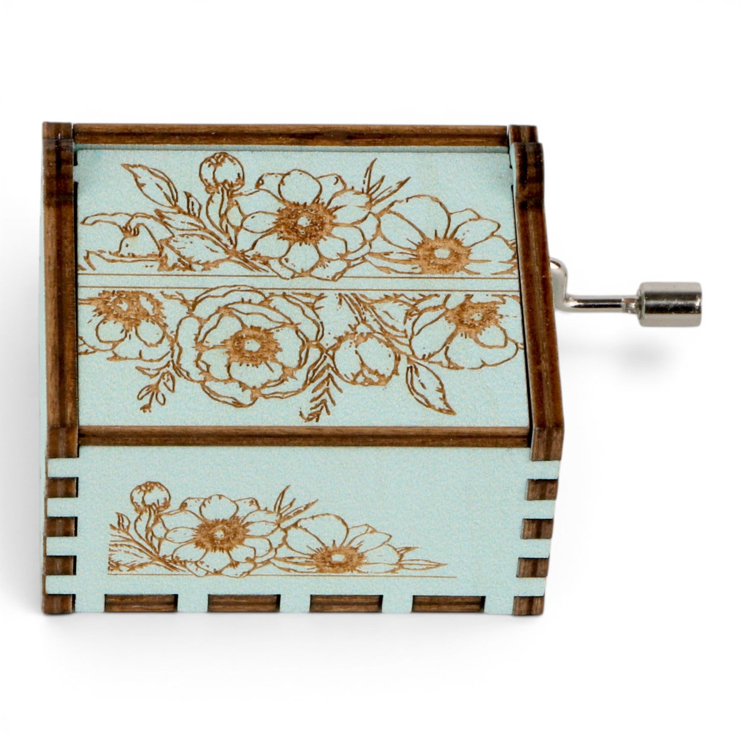 Enchanted Music Boxes hand-crank music box in light blue plywood with intricate vintage-style floral engravings.