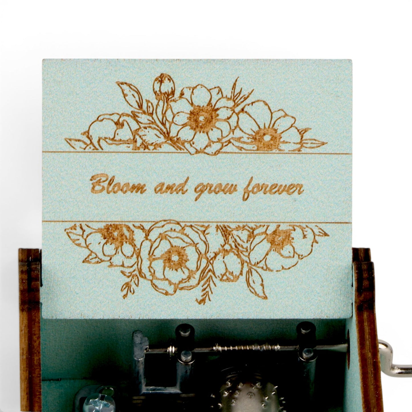 Enchanted Music Boxes hand-crank music box with light blue lid featuring floral engravings and Bloom and grow forever