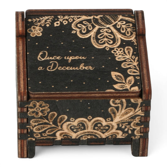 Enchanted Music Boxes wind-up plywood music box featuring dark wood with intricate floral laser-engraved patterns.