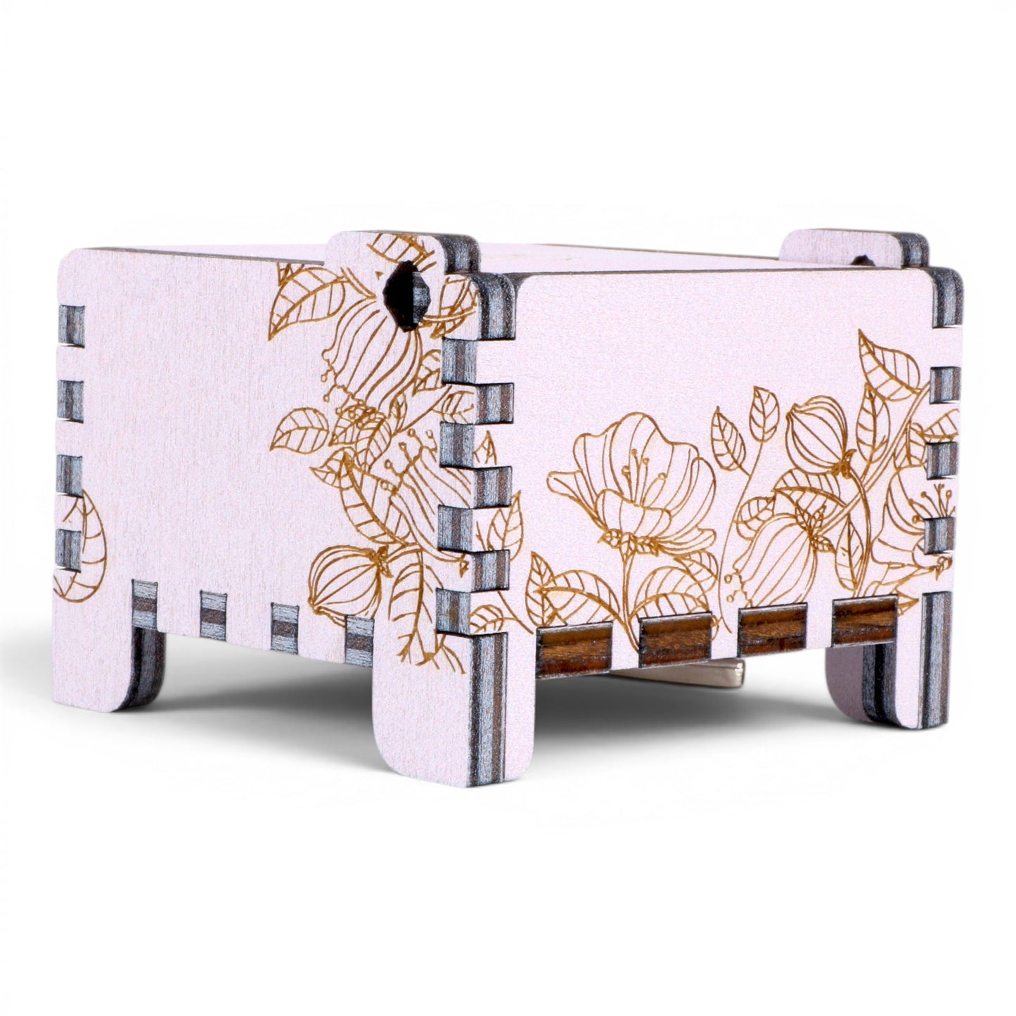 Side view of Enchanted Music Boxes wind-up music box in light purple plywood with delicate gold floral and leaf engravings.