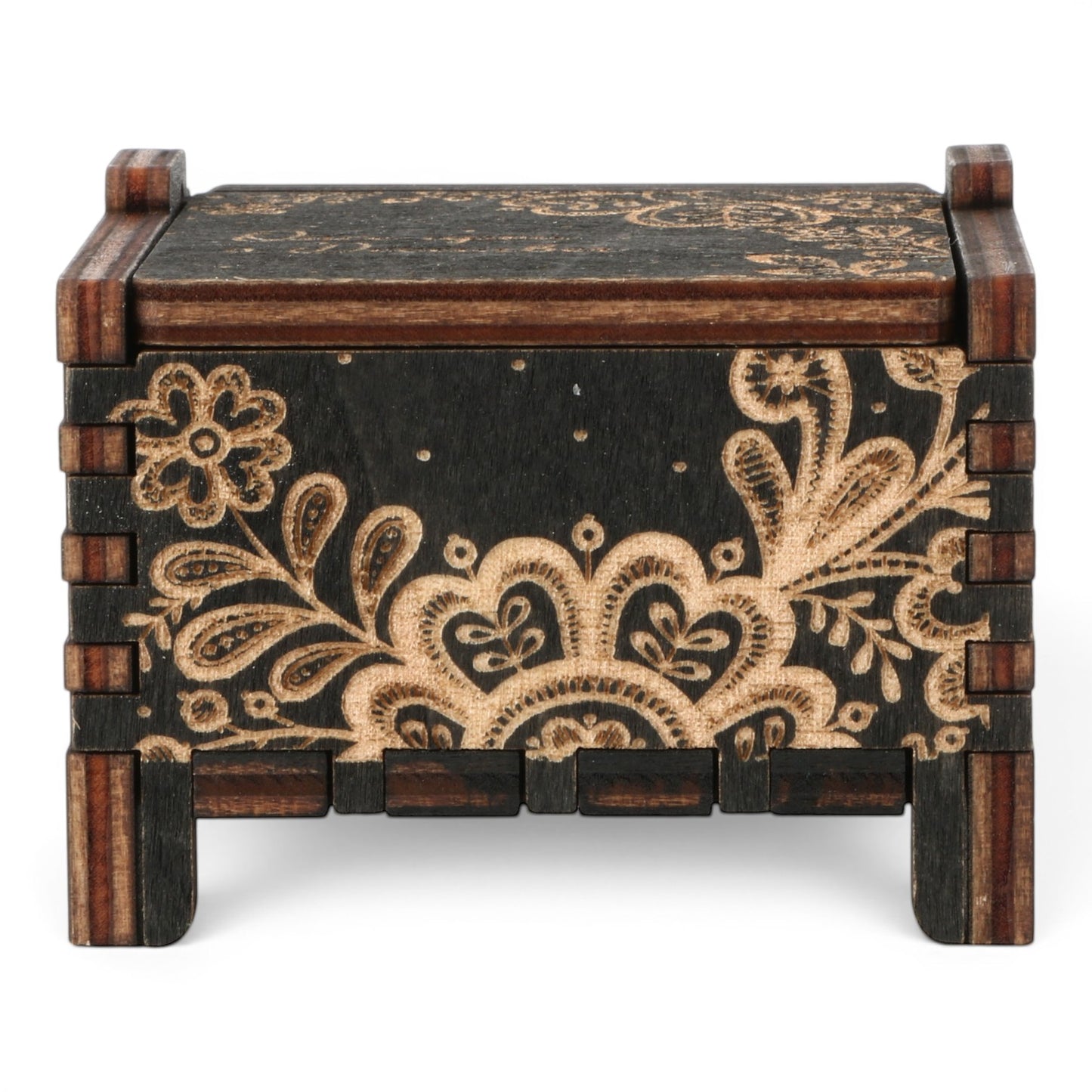 Front view of Enchanted Music Boxes Ethnic Nature wind-up music box in dark plywood with intricate floral and dotted folk art design.