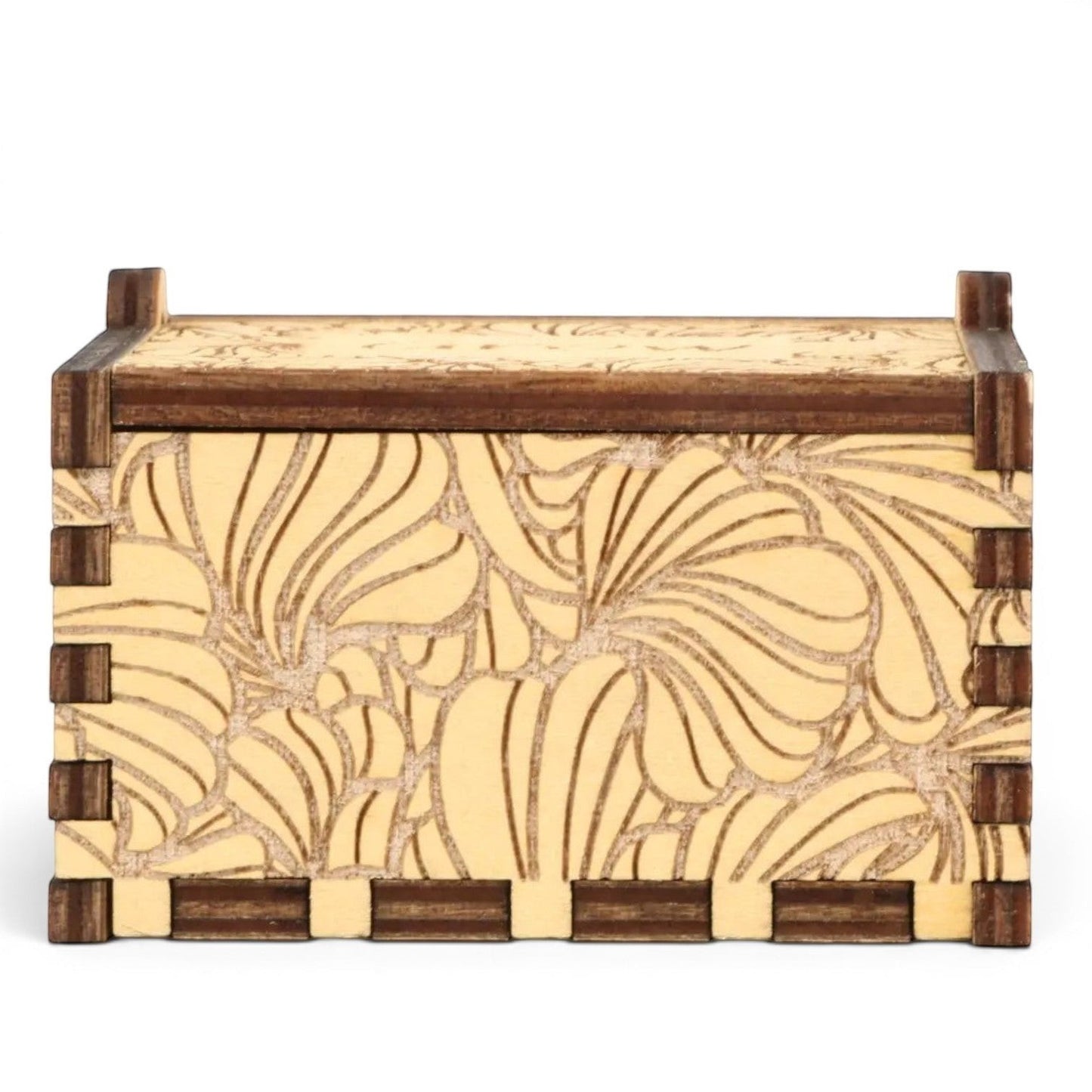 Enchanted Music Boxes plywood hand-crank music box with laser-engraved floral petal patterns on a light wood finish.