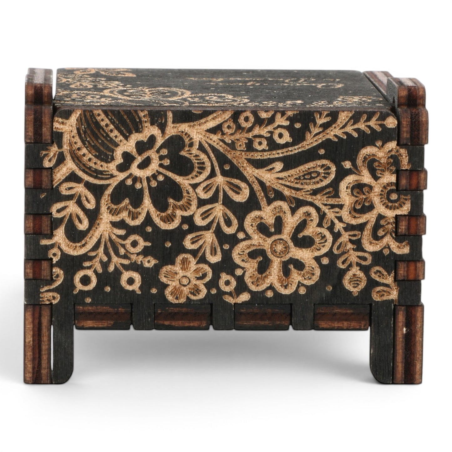 Back view of Enchanted Music Boxes wind-up music box in dark plywood with intricate laser-engraved floral and folk art patterns.