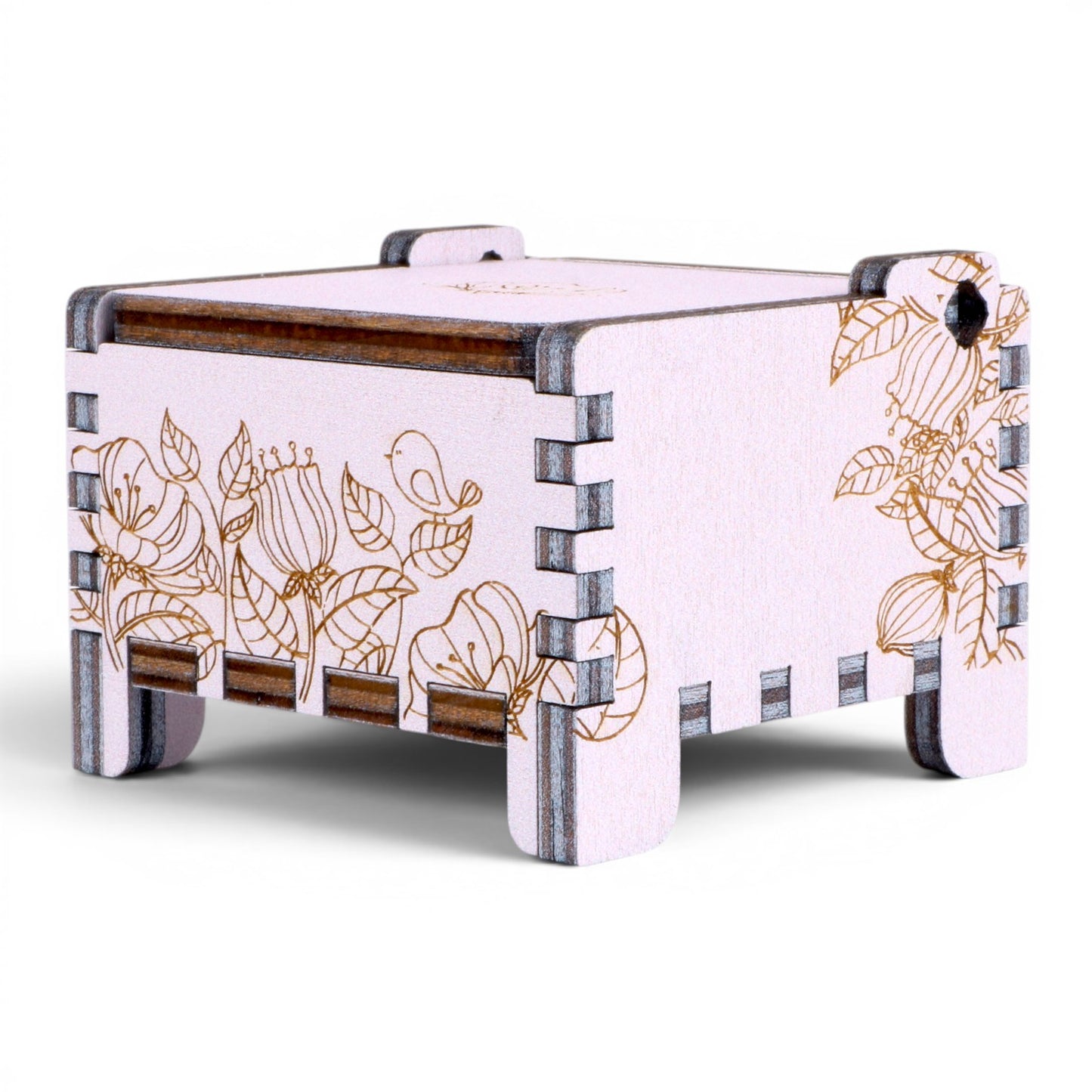 Side view of Enchanted Music Boxes wind-up music box in light purple plywood with intricate floral and bird line engravings.
