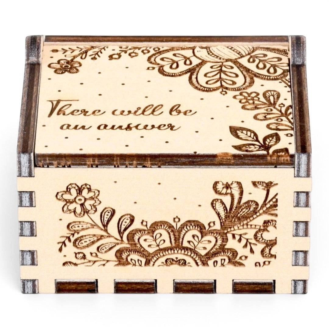 Enchanted Music Boxes hand-crank plywood music box featuring intricate folk art floral engravings and custom text.