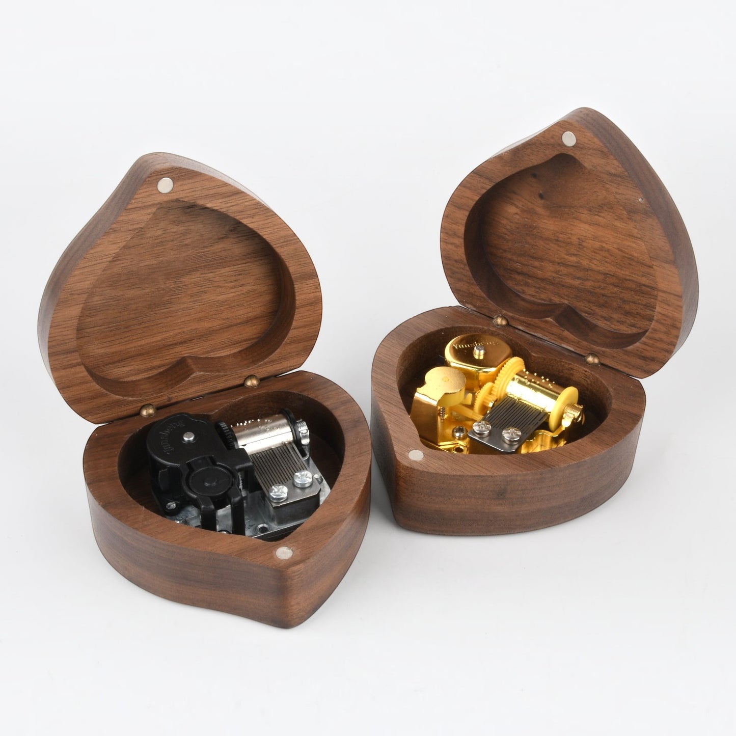 Two Enchanted Music Boxes heart-shaped plywood music boxes with open lids revealing internal wind-up mechanisms.