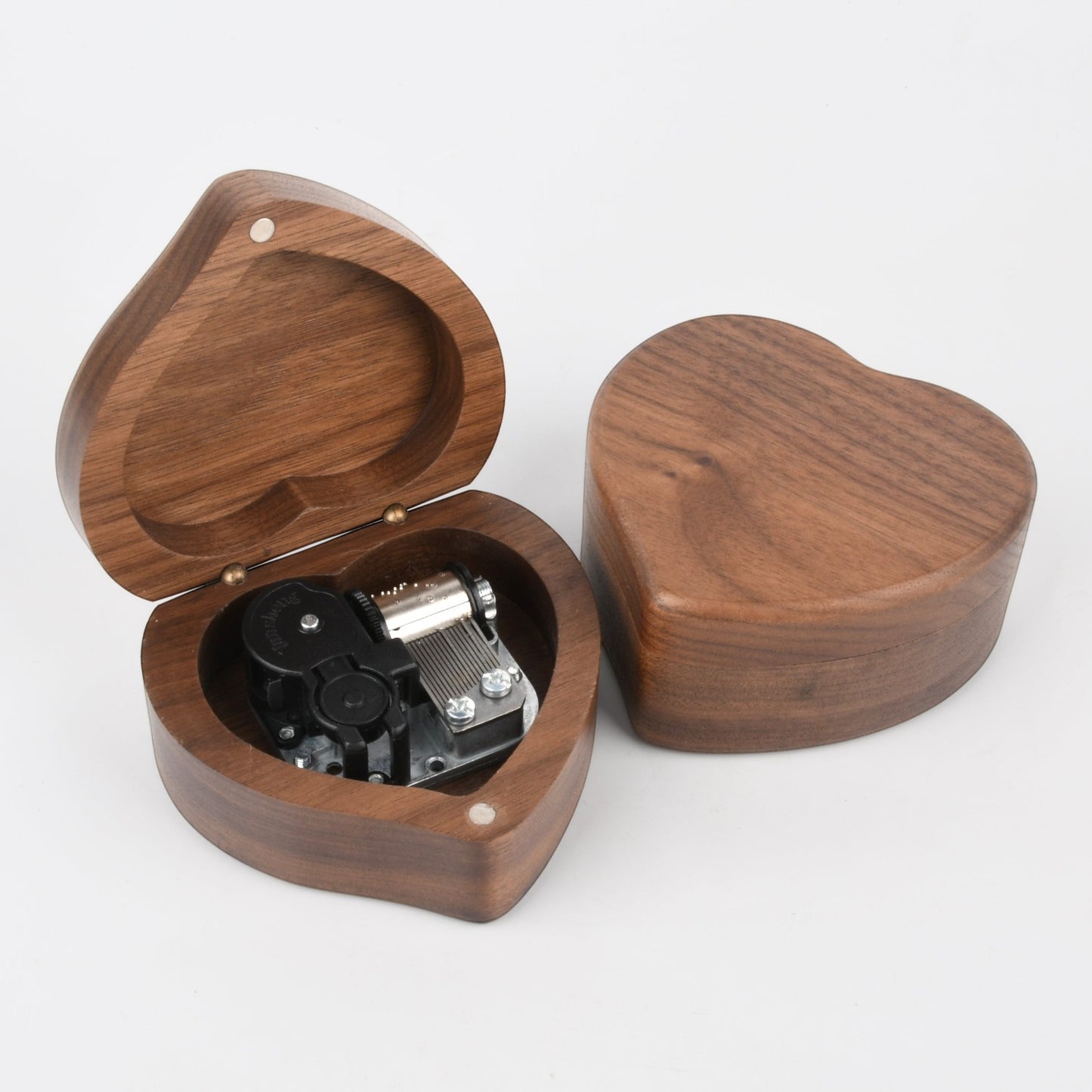 Enchanted Music Boxes heart-shaped wooden wind-up music box with visible metal mechanism in an open and closed view.