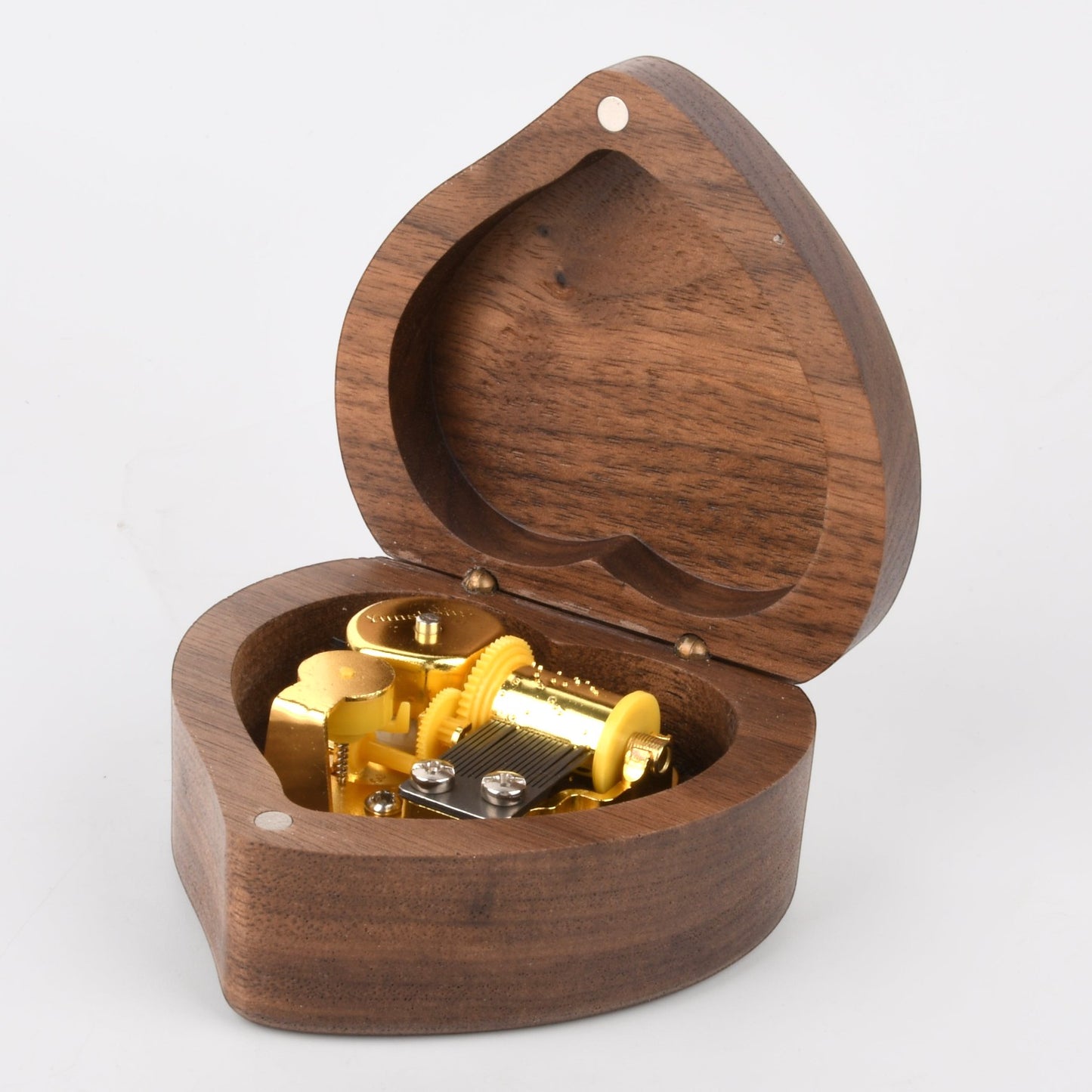 Enchanted Music Boxes heart-shaped wooden music box with an open lid revealing the gold-toned internal metal mechanism.