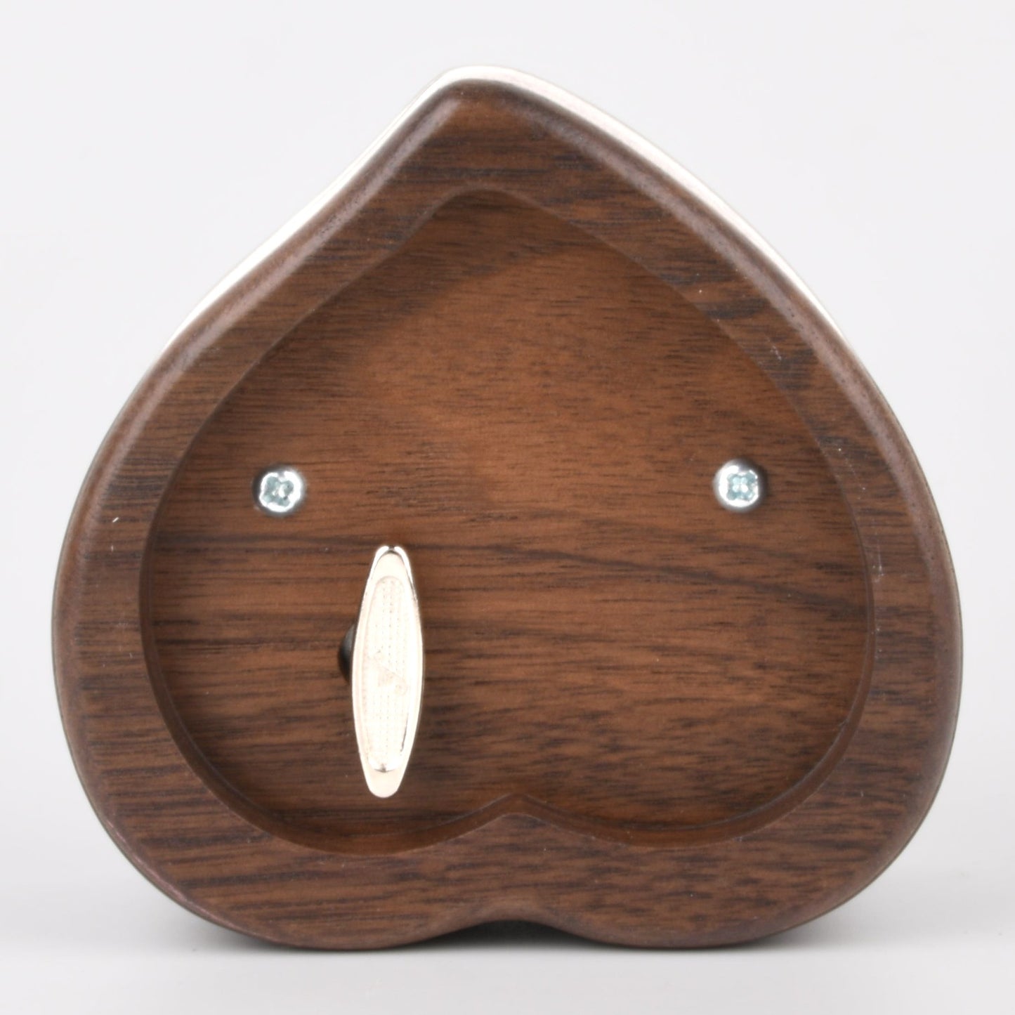 Enchanted Music Boxes heart-shaped wooden music box showing the metal wind-up key on the underside.