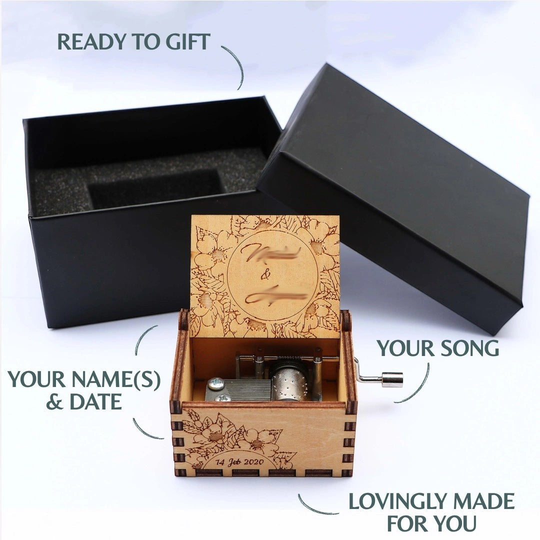 Enchanted Music Boxes personalised plywood hand-crank music box with cherry blossom engraving and gift box packaging.