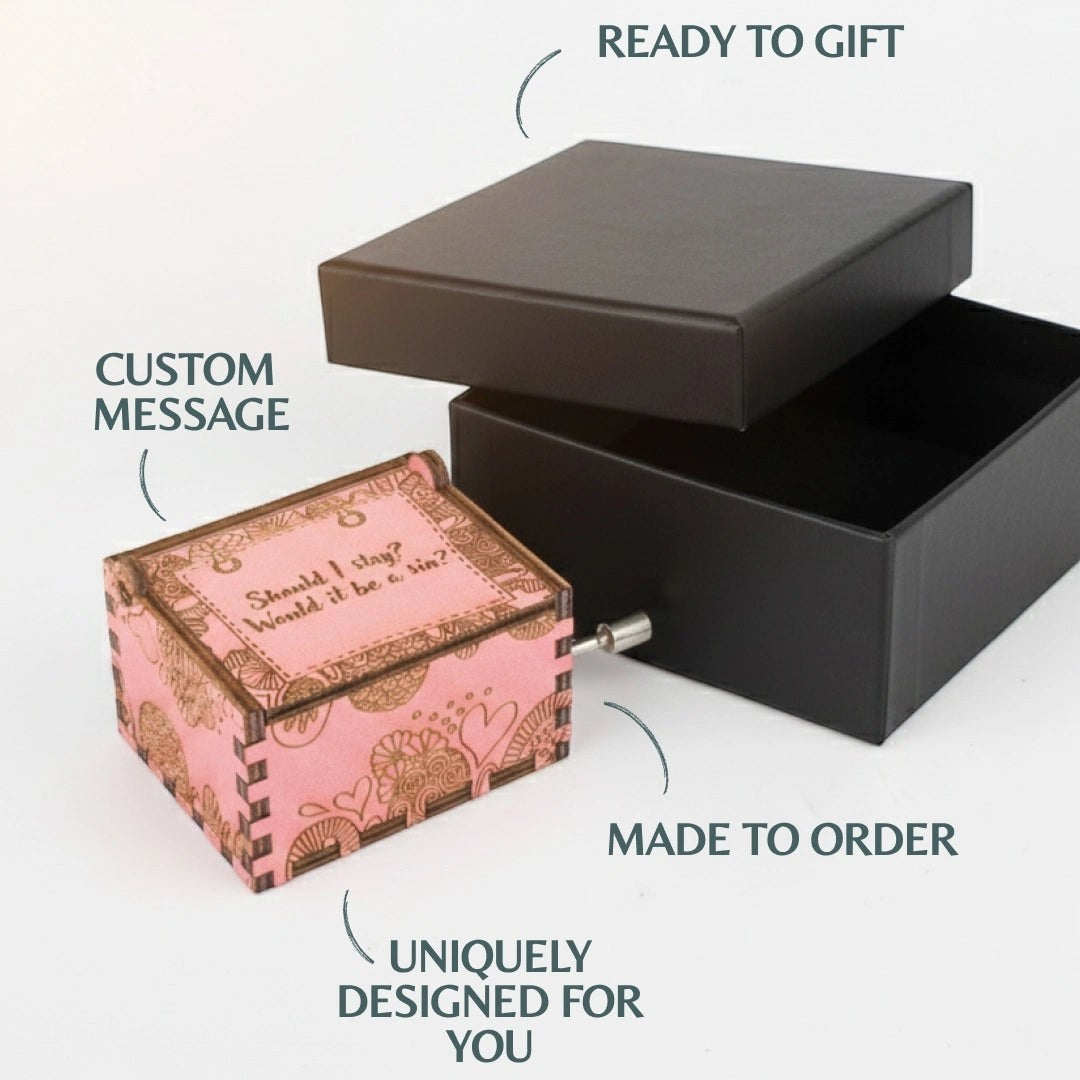 Enchanted Music Boxes hand-crank music box with pink zentangle pattern and custom engraved lid message next to gift box