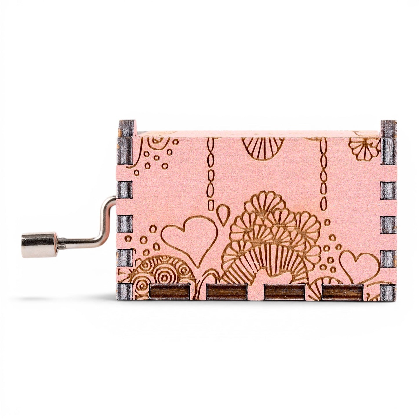 Enchanted Music Boxes hand-crank music box in pink plywood with engraved zentangle hearts and swirl patterns.