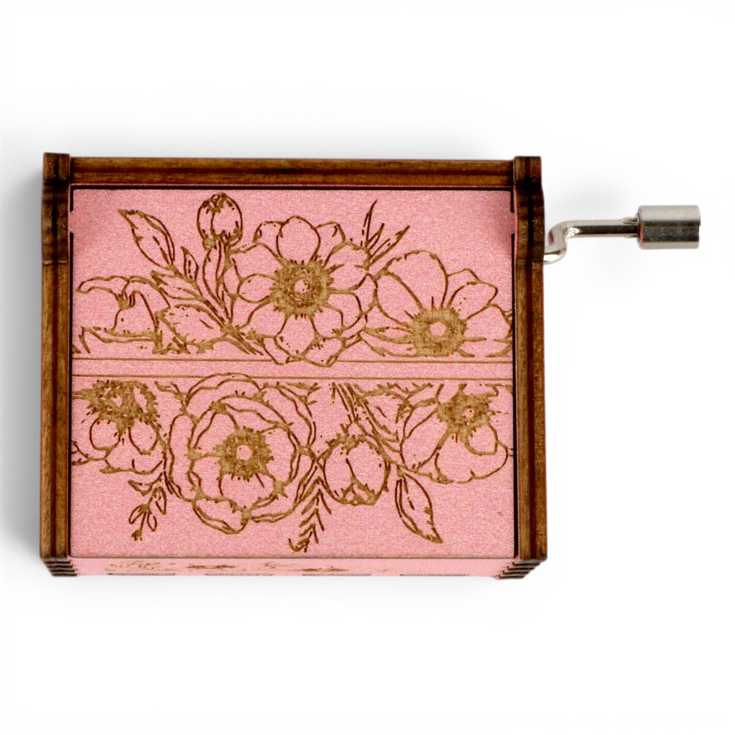 Enchanted Music Boxes hand-crank music box with pink floral engravings on a plywood lid and metal crank handle.