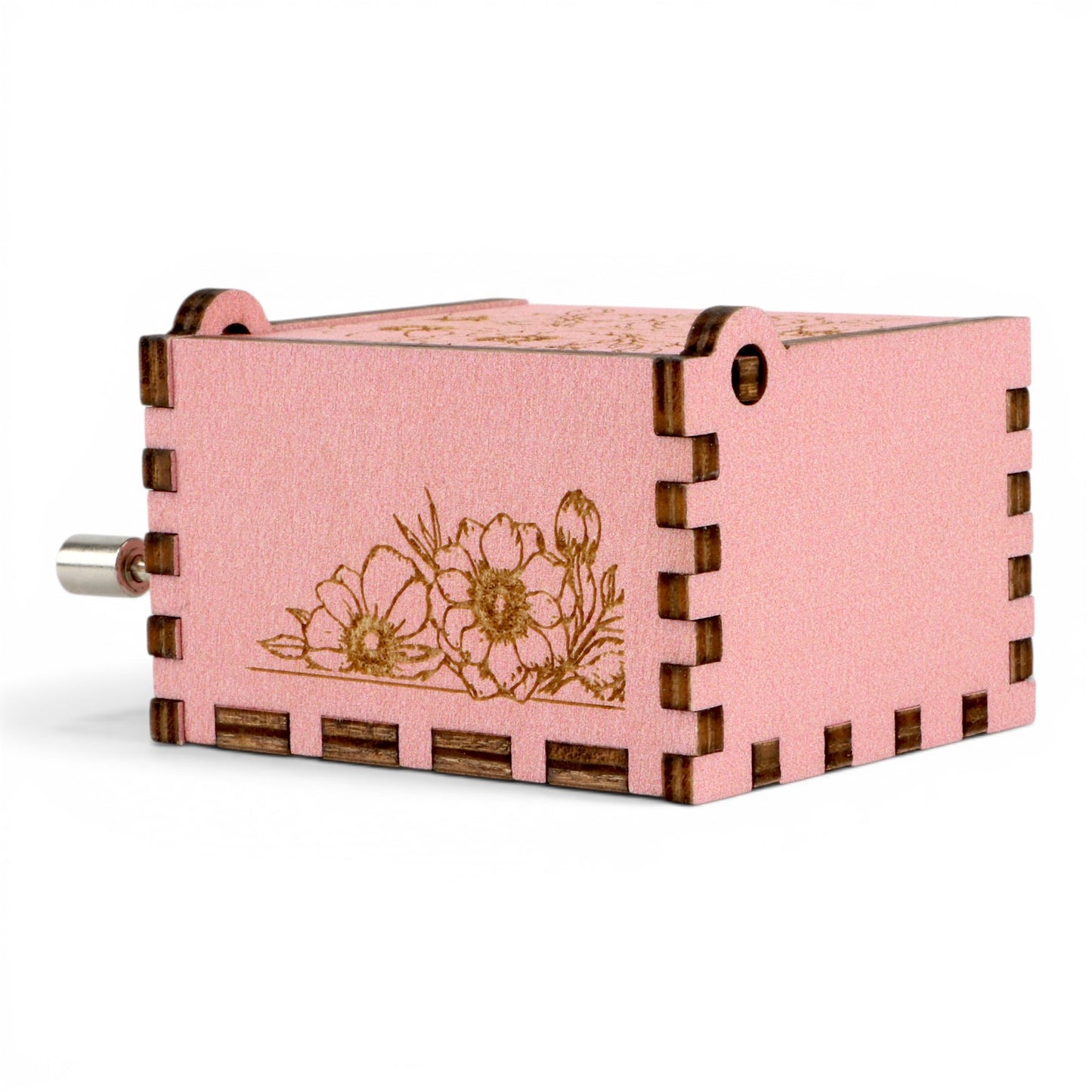 Enchanted Music Boxes pink plywood hand-crank music box with delicate laser-engraved floral patterns on the side.