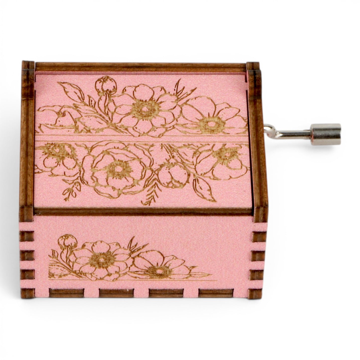 Enchanted Music Boxes pink plywood hand-crank music box with intricate vintage floral engravings and metal handle.