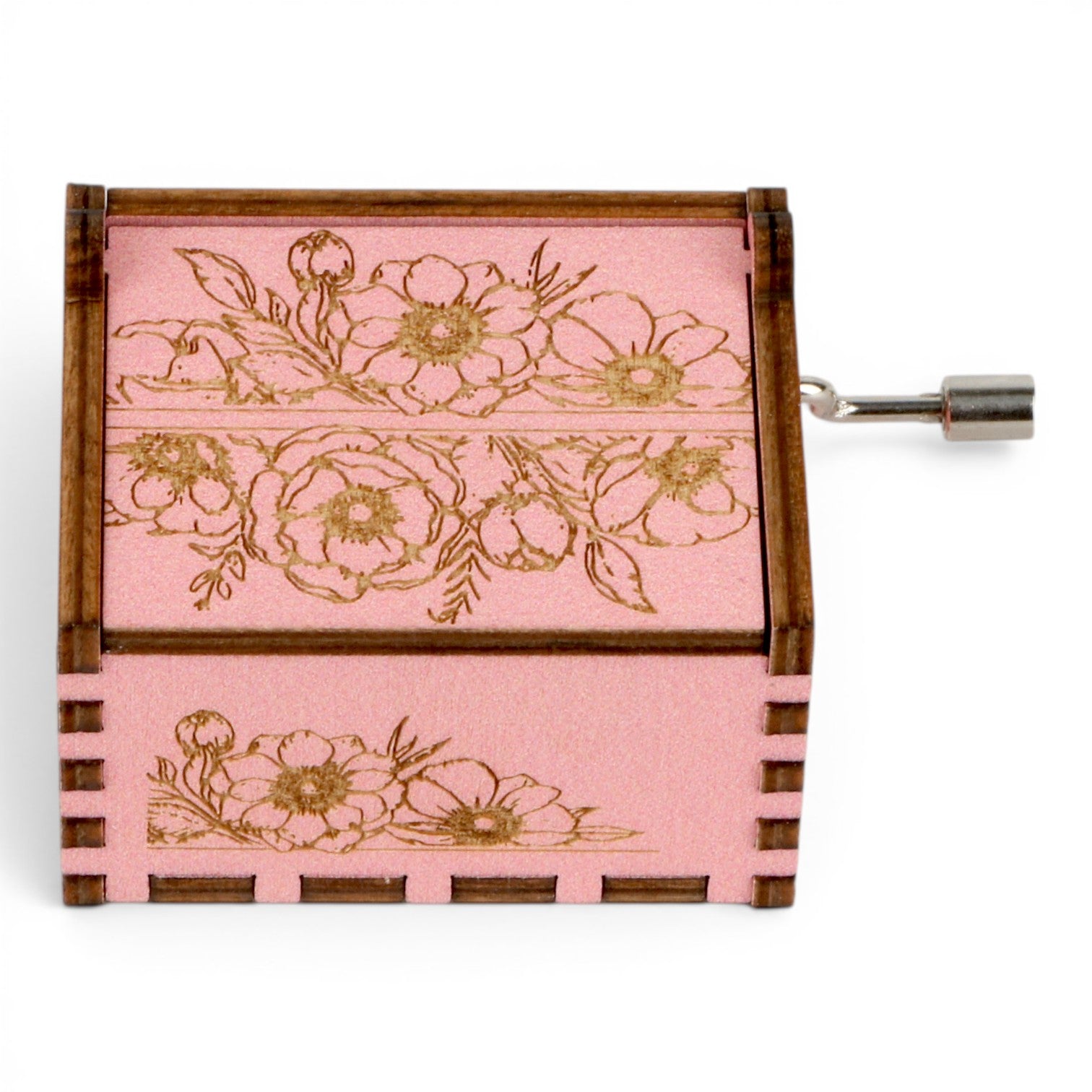 Enchanted Music Boxes pink plywood hand-crank music box with intricate vintage floral engravings and metal handle.