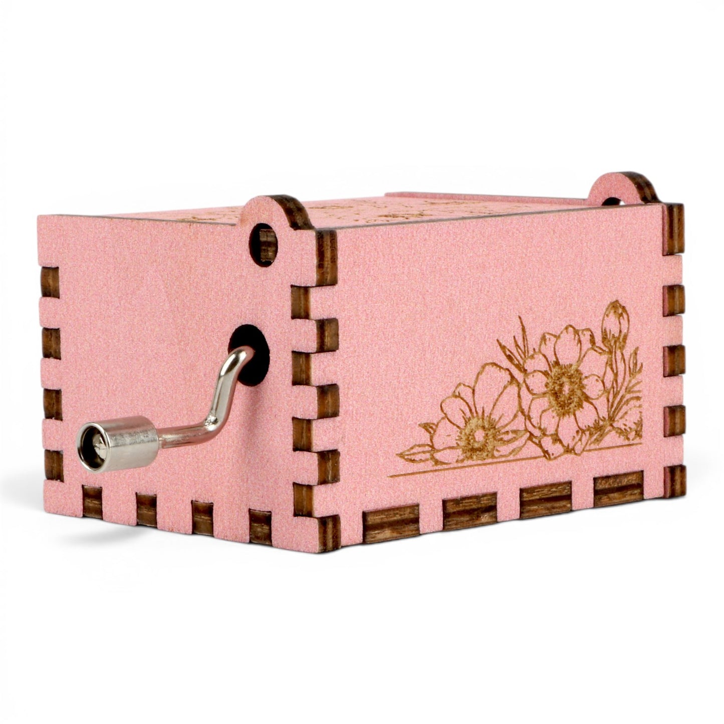 Enchanted Music Boxes pink plywood hand-crank music box with intricate floral engravings and a metal handle.