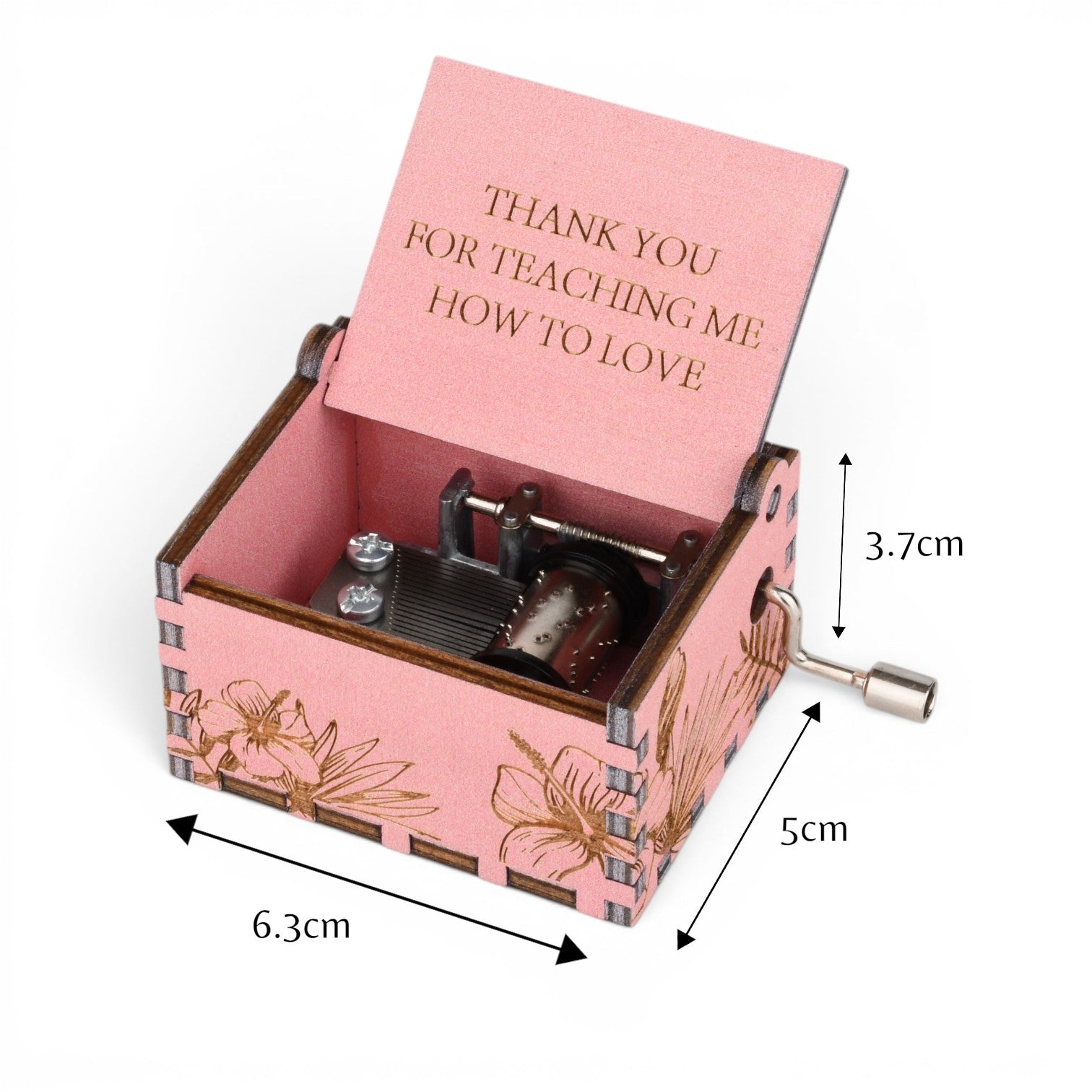 Enchanted Music Boxes pink plywood hand-crank music box with laser-engraved hibiscus flowers and custom lid inscription.