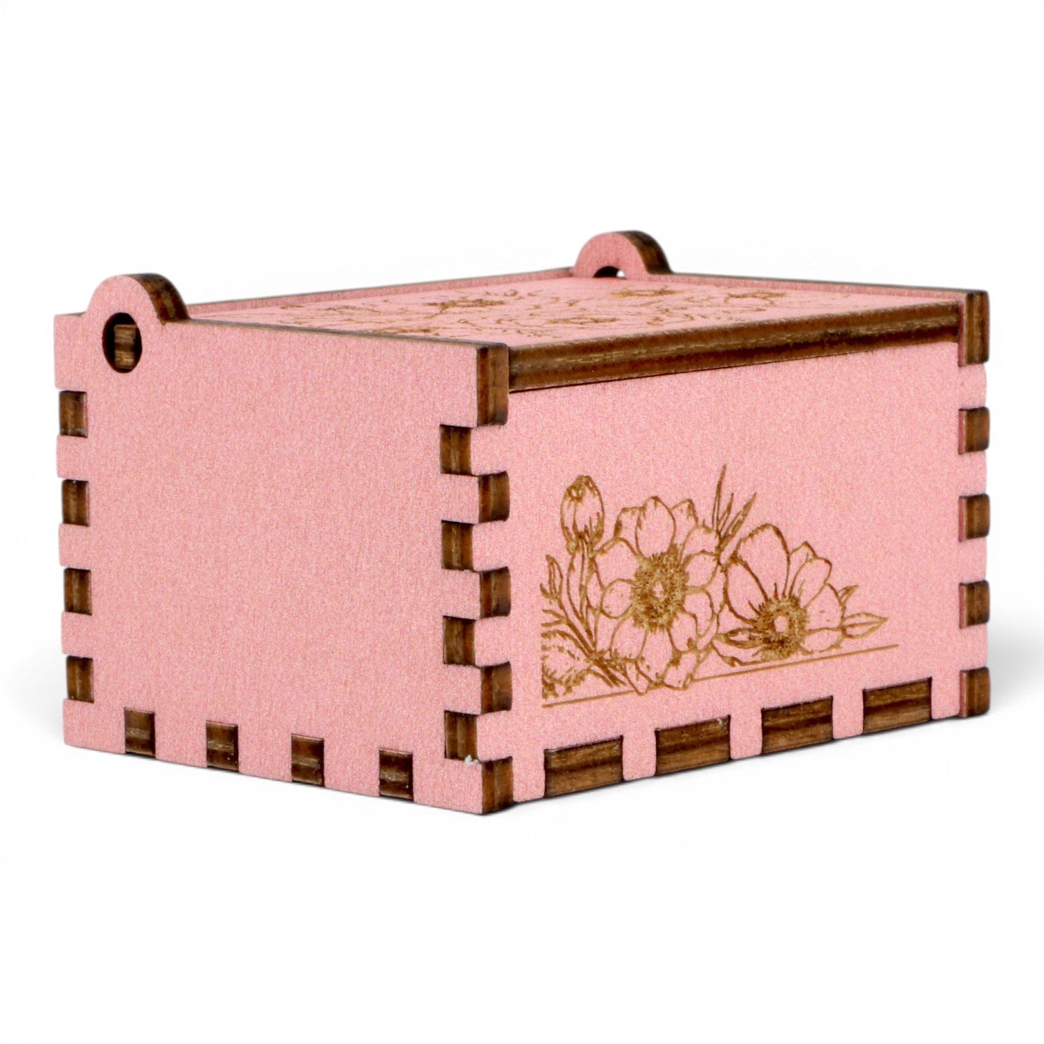 Enchanted Music Boxes pink plywood music box with delicate laser-engraved floral patterns and finger-joint corners.