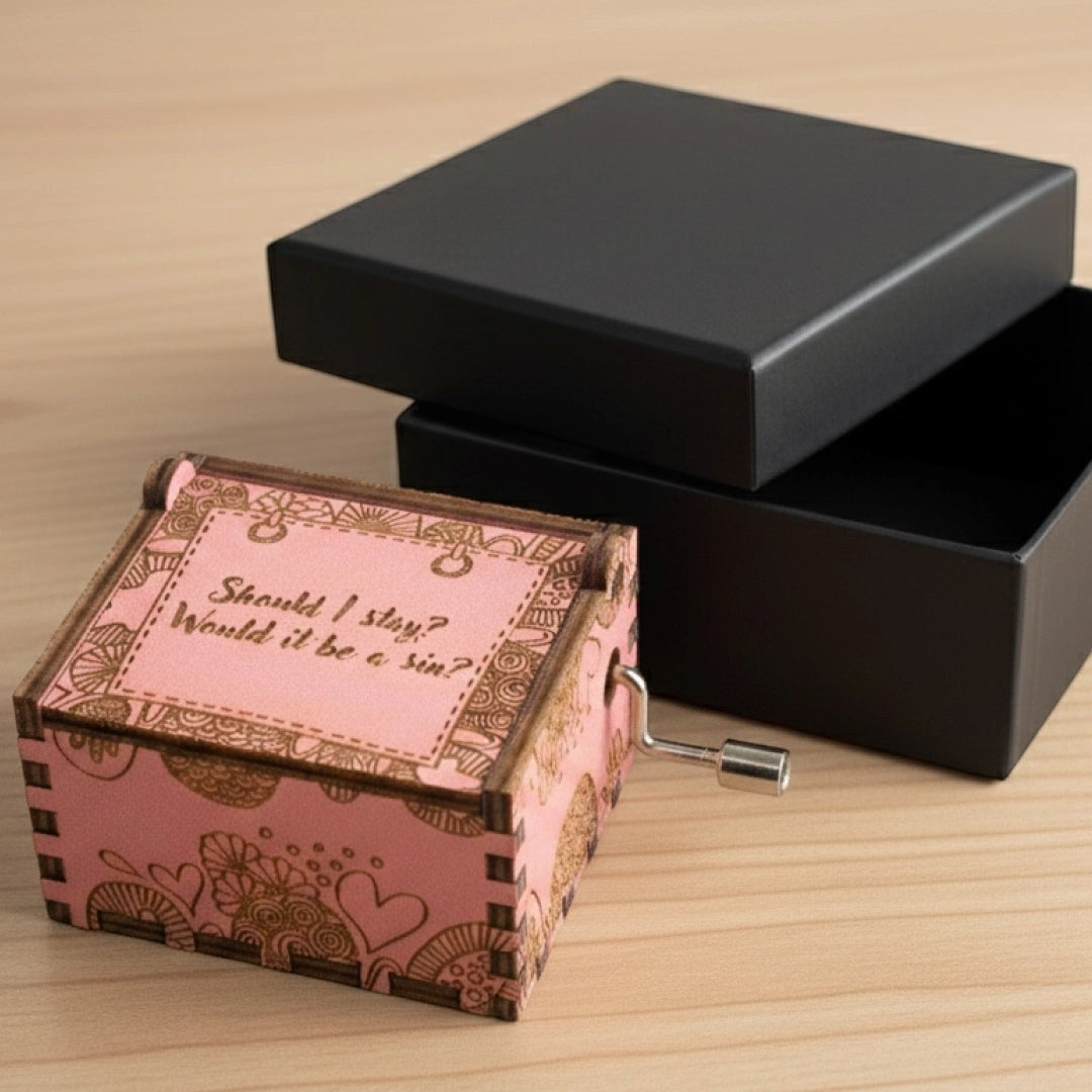 Enchanted Music Boxes hand-crank plywood music box with pink zentangle design and engraved lid on a wooden surface