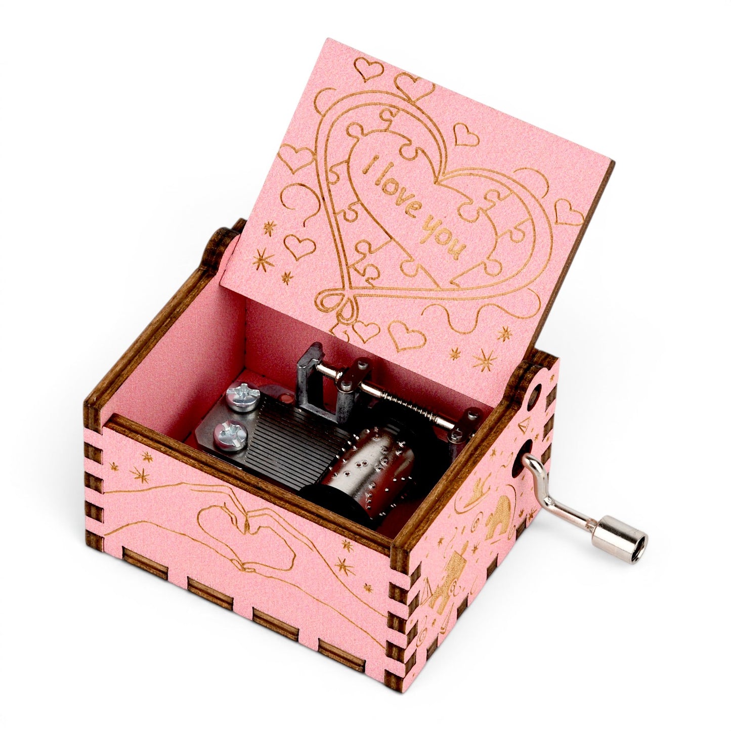 Enchanted Music Boxes pink plywood hand-crank music box with heart and puzzle piece engravings on the lid and sides.