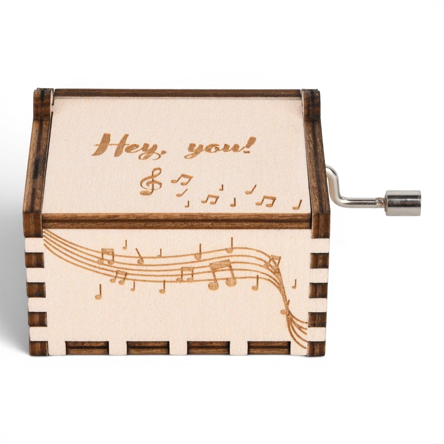 Enchanted Music Boxes hand-crank music box in light plywood with engraved music notes and Hey you text on the lid.