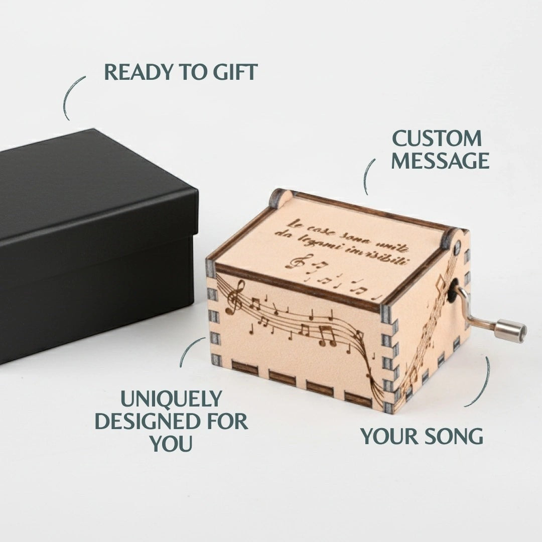 Enchanted Music Boxes hand-crank plywood music box with laser-engraved music notes and cursive text on lid