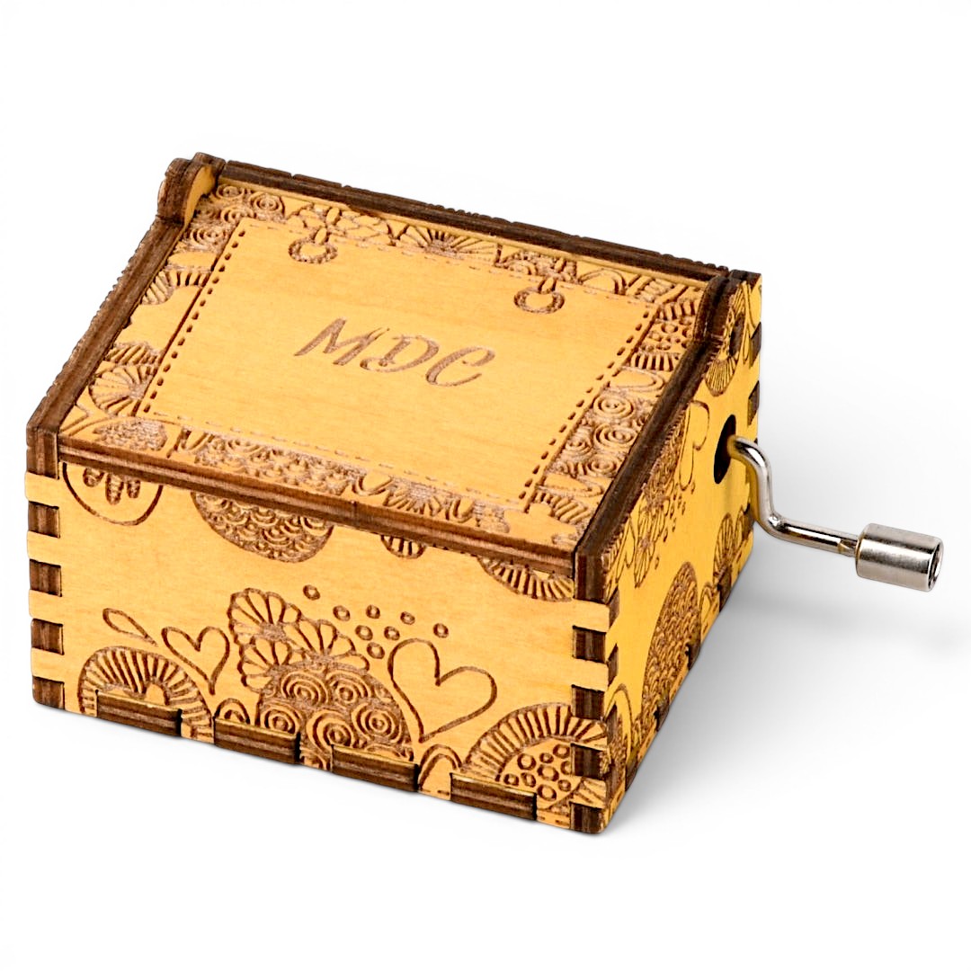 Enchanted Music Boxes plywood hand-crank music box with engraved zentangle swirls, hearts, and custom lid monogram.