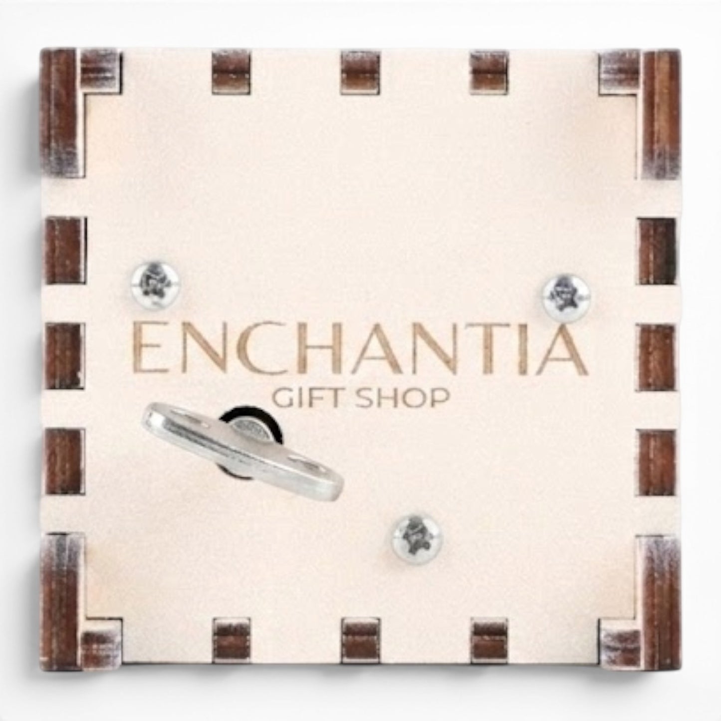 Bottom view Enchanted Music Boxes plywood wind-up music box underside with metal key and Enchantia Gift Shop branding