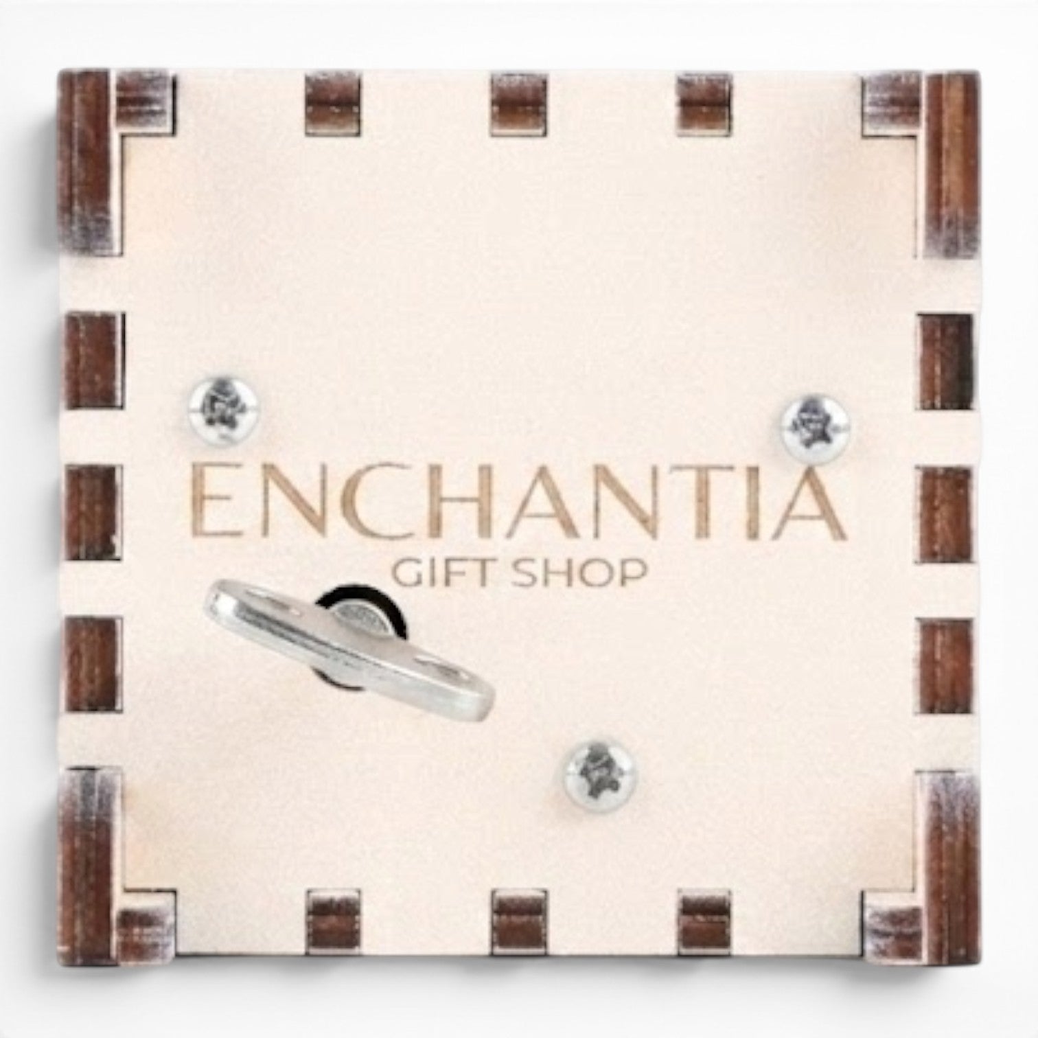 Bottom view Enchanted Music Boxes plywood wind-up music box underside with metal key and Enchantia Gift Shop branding