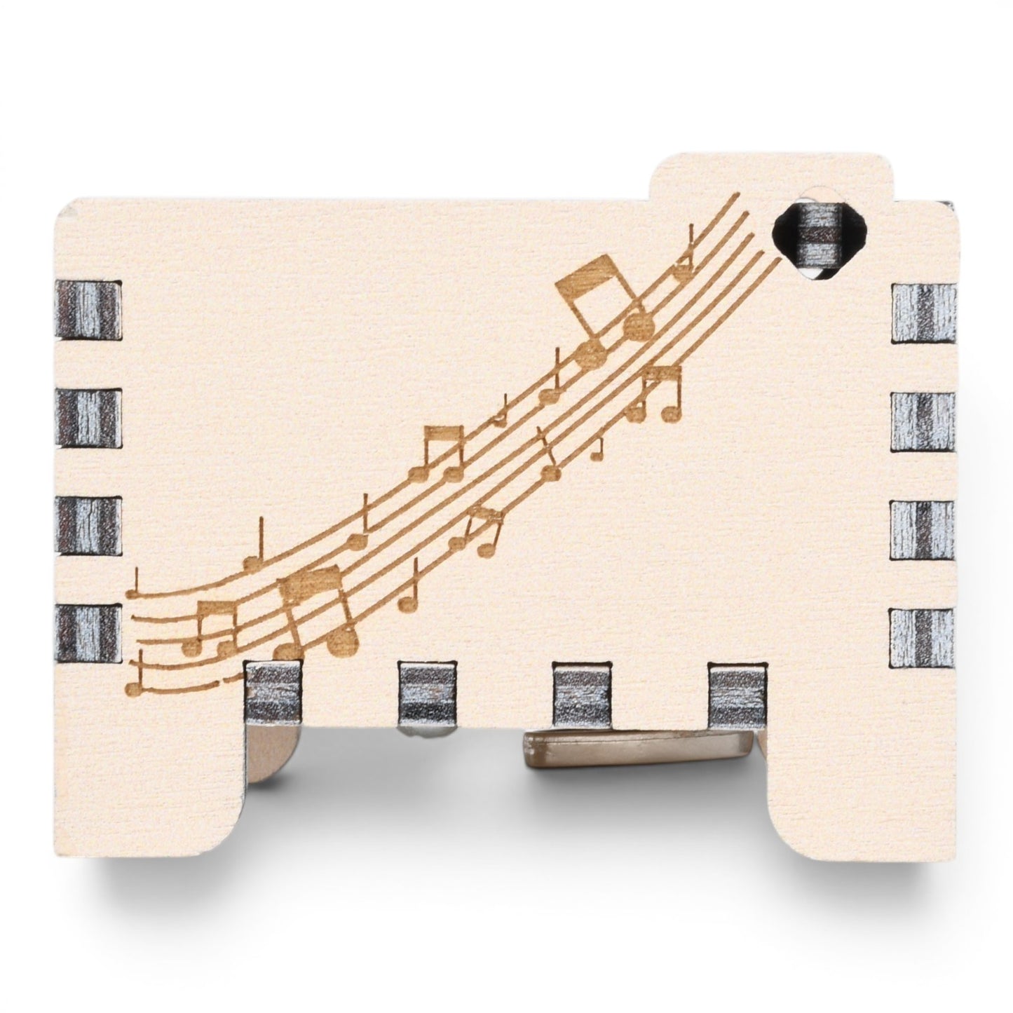 Enchanted Music Boxes plywood wind-up music box featuring engraved musical staves and notes on a light wood surface.