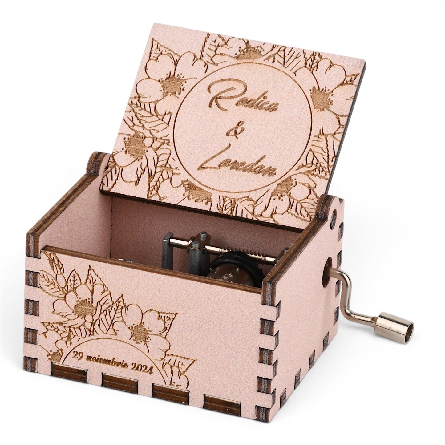 Enchanted Music Boxes personalised plywood hand-crank music box with cherry blossom engraving and metal mechanism.