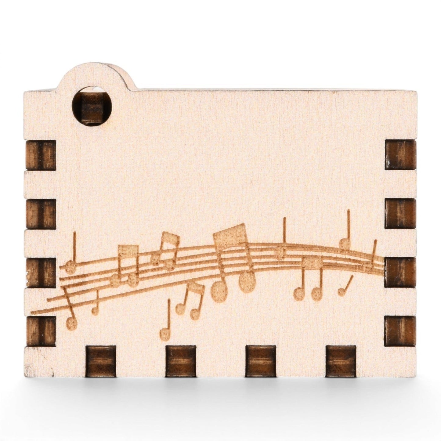 Enchanted Music Boxes hand-crank music box made of light plywood with engraved musical notes and staff lines.