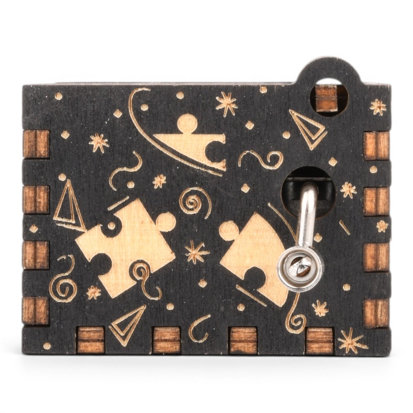 Enchanted Music Boxes puzzle piece hand-crank music box made of black and natural plywood with engraved details.