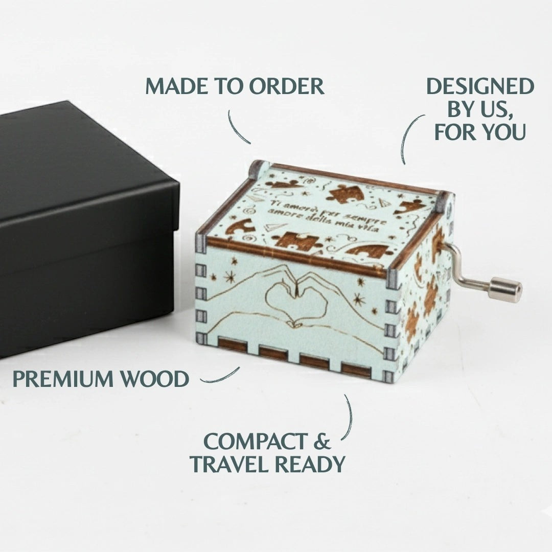 Enchanted Music Boxes puzzle piece hand-crank music box in plywood with heart hands and romantic engravings