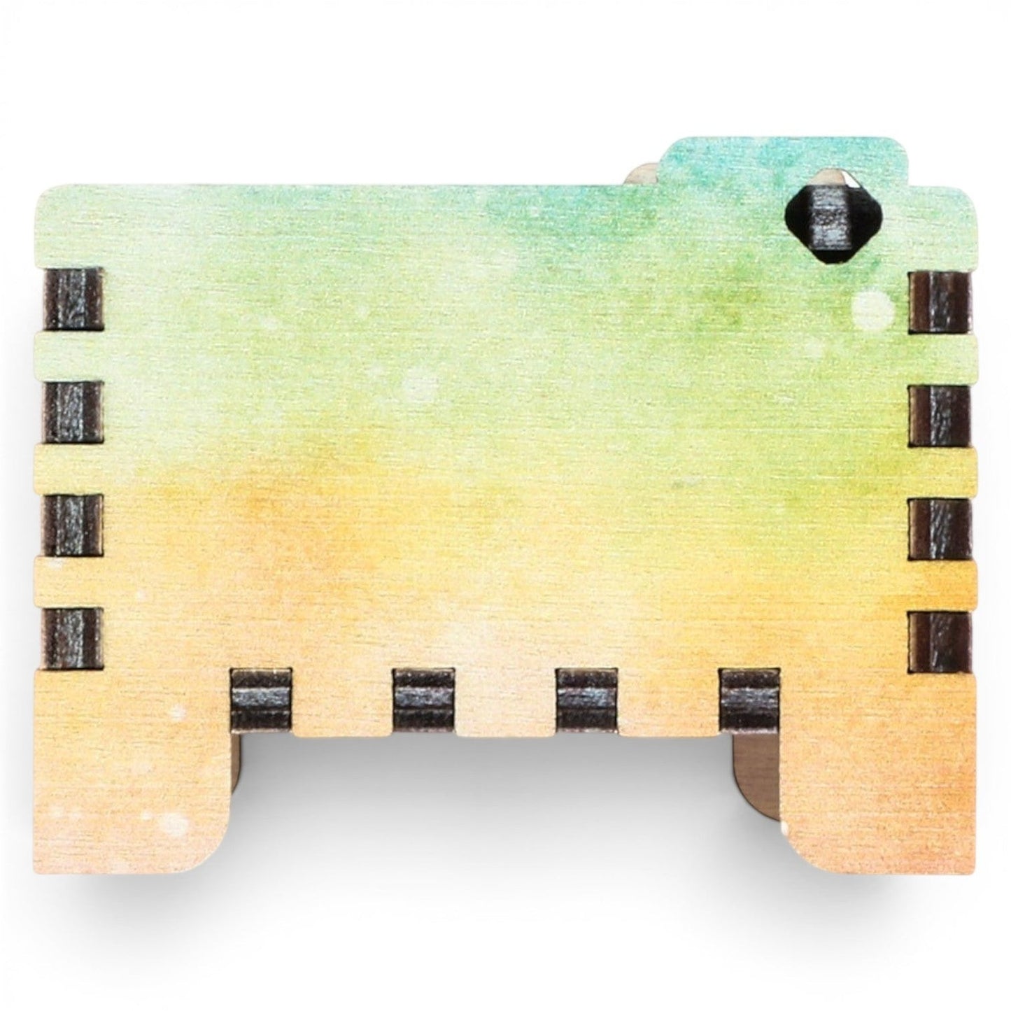 Enchanted Music Boxes rainbow plywood wind-up music box with a watercolour gradient finish and interlocking joints.