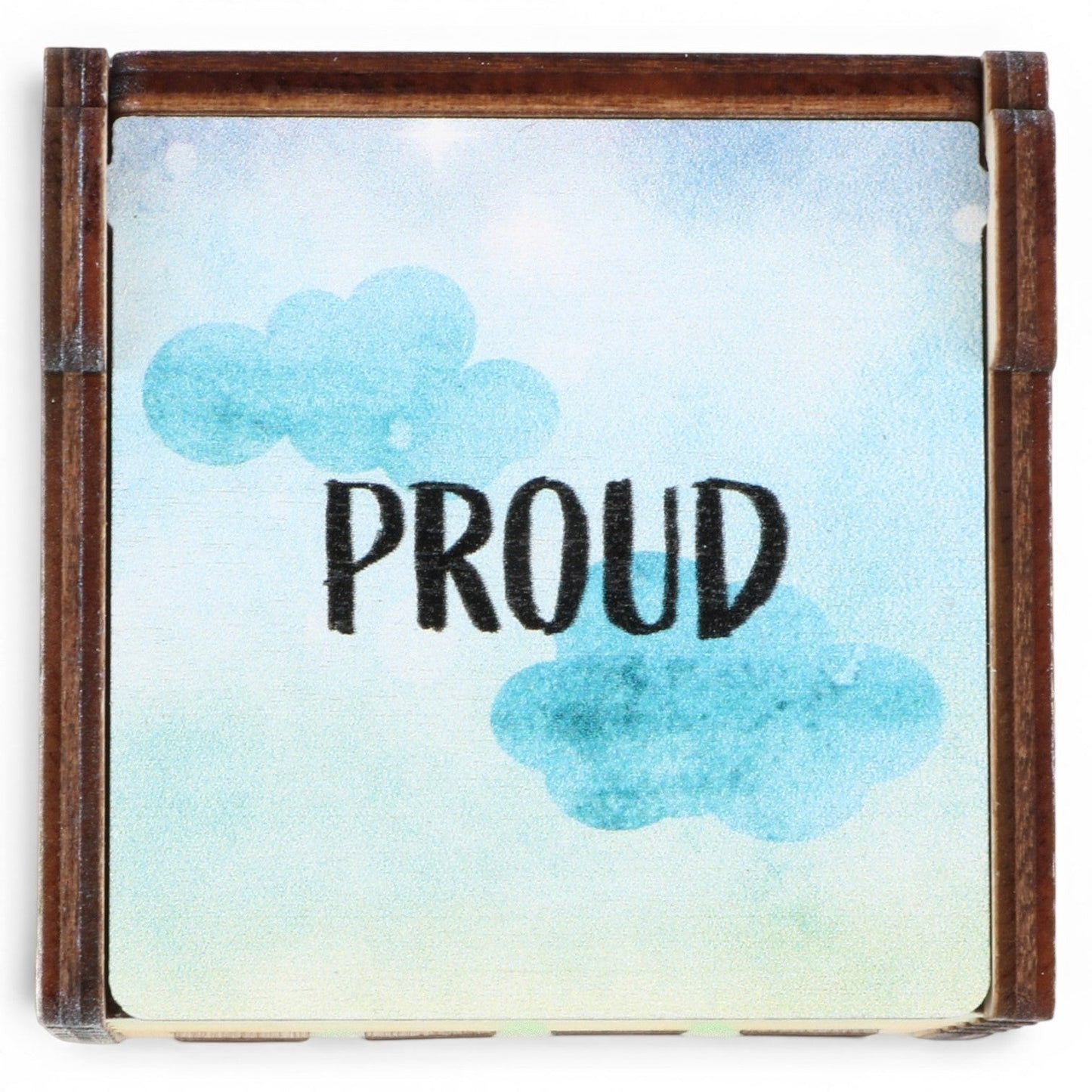 Enchanted Music Boxes rainbow wind-up music box with watercolour sky design and the word PROUD printed on the lid.