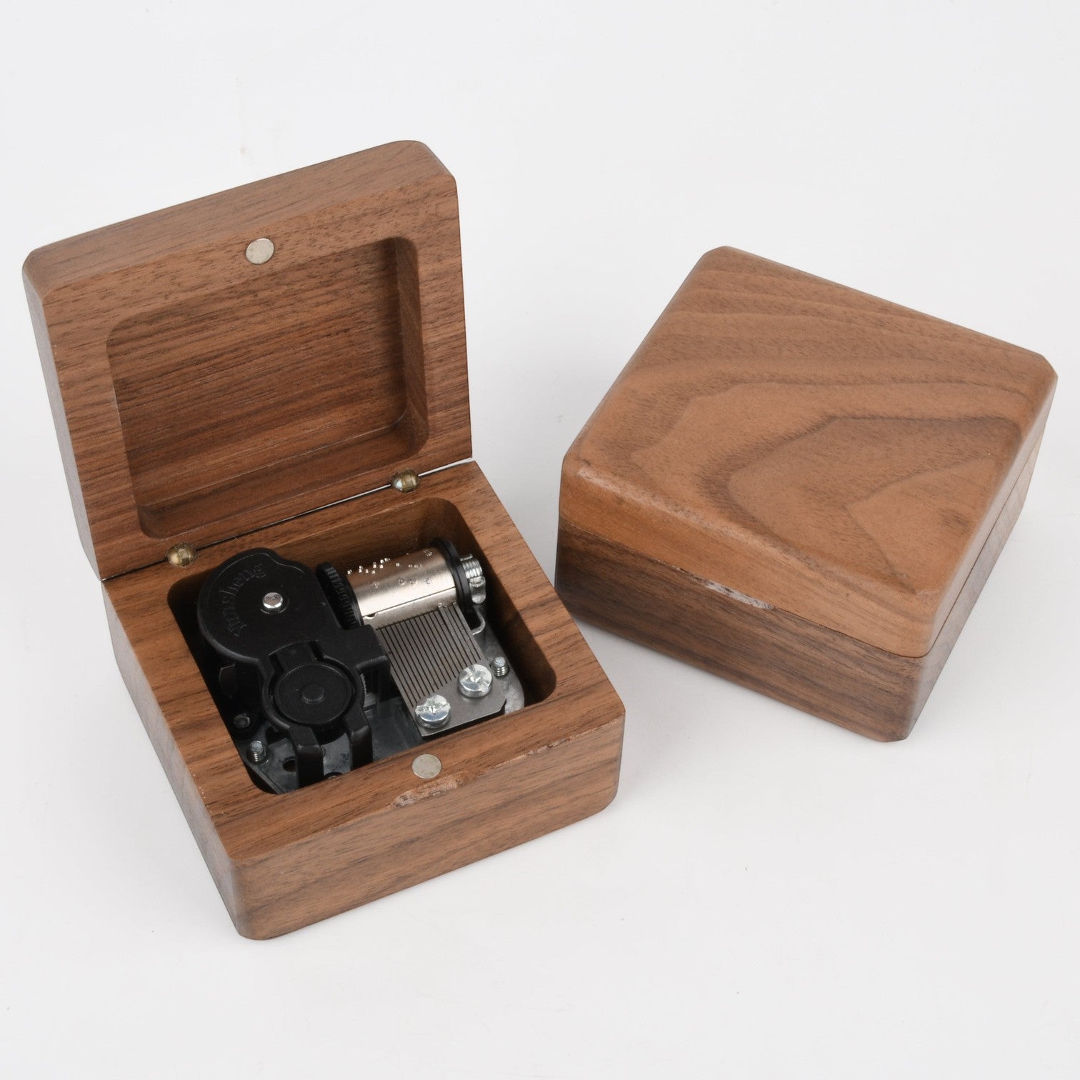 Enchanted Music Boxes square wooden wind-up music box with visible metal mechanism, shown open and closed.
